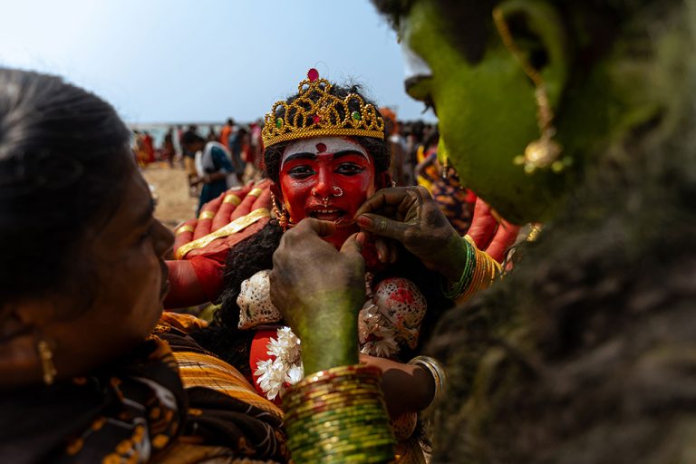 Amidst the vibrant celebrations of Kulasai Dasara, parents dressed as deities tenderly adjust their daughter's costume, embodying the spirit of togetherness, tradition and love